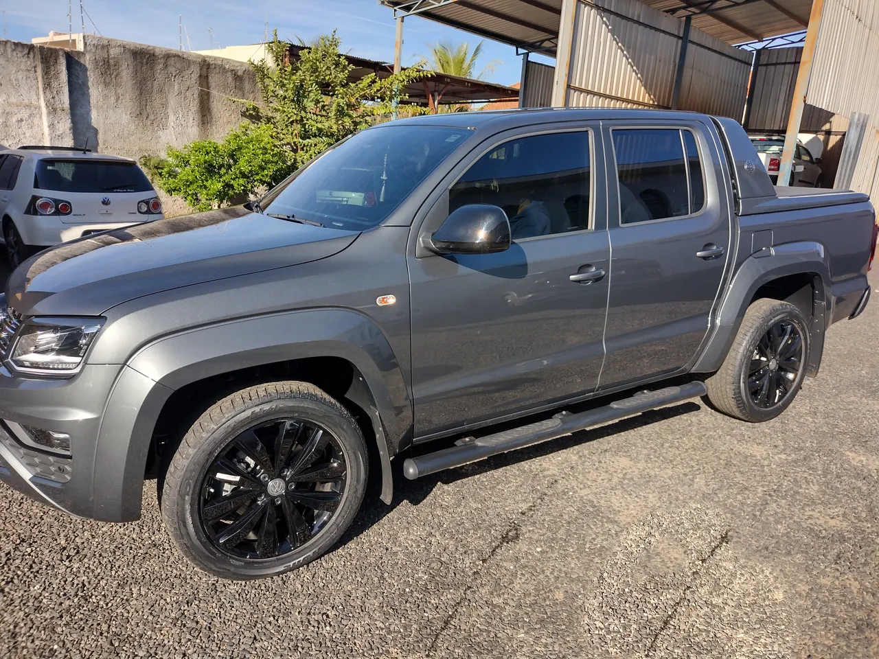 Volkswagen Amarok cinza com rodas pretas, limpa e brilhando, no pátio da Santo Antônio